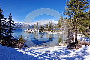 Snow-covered beach at Sand Harbor Nevada State Park. Lake Tahoe, Nevada side.