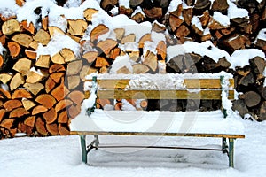 Snow Covered Bench by Woodpile