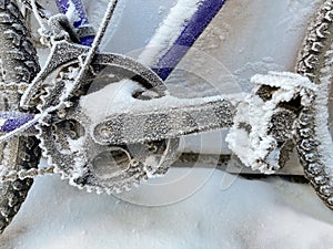 Snow covered bike outdoors in winter