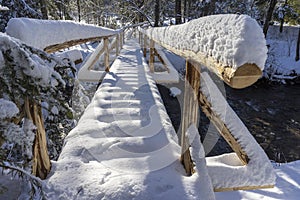 Snow-covered bridge in a mountain forest. Around Oravice. Slovakia