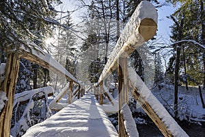 Snow-covered bridge in a mountain forest. Around Oravice. Slovakia