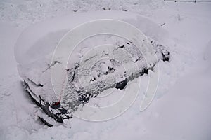 Snow covered car with deep snow