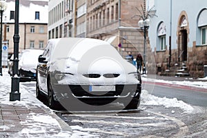 Snow covered car parked at the roadside