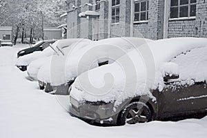 Snow-covered car in the parking lot