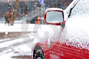 Snow-covered car on parking in winter