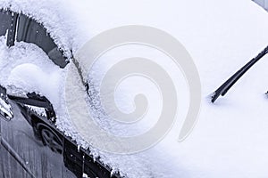 Snow covered car. Snowdrift of snow by car.