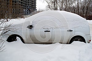 Snow covered car after snowfall