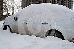 Snow covered car after snowfall