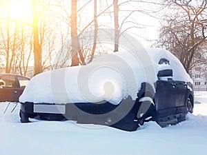 Snow-covered car after snowfall in night city