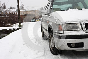 Snow covered car during a snowstorm