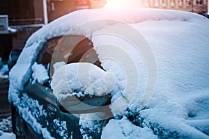 Snow-covered car. Transport after snowfall. Winter parking.