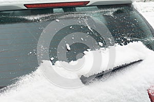 Snow-covered car windshield. parked car covered with snow during snowing in winter time