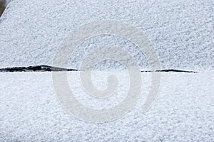 snow covered car windshield, wipers and bonnet