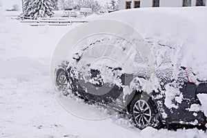 Snow covered car. Winter in the Austrian Alps. Heavy snowfall