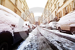 Snow-covered cars on Paris streets after snowstorm