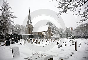 Snow covered church and grave yard
