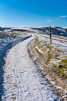 Snow covered Cleeve Hill, Cotwolds, Gloucestershire, UK on a sunny winters day photo