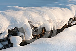 Snow covered dry stone wall