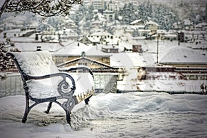 Snow covered empty bench