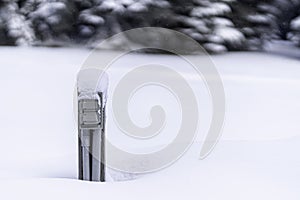 Snow covered engine block heater a parking lot in middle of a snow storm