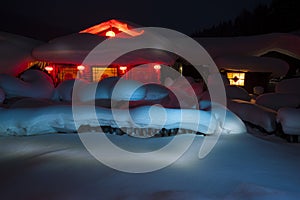 SNOW-COVERED FARMHOUSE IN THE NIGHT