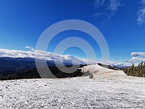 A snow covered field side of a snow covered mountain