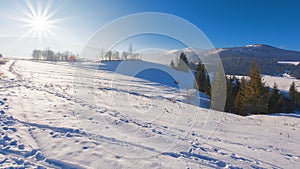 snow covered fields in rural area of ukrainian carpathians