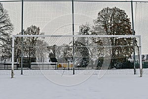 A snow-covered football goal. The concept of the end of the football season, the football league and the end of the