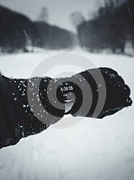 Snow covered and frozen wooden cabins in the middle of mountain forest with stream on background in winter. Snowy slovak