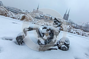 Snow covered gnome in a winter scenery, in the background a visible St. John the Baptist Cathedral - WrocÃâaw, Poland