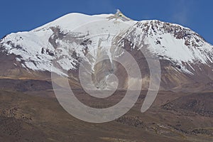 Snow covered Guallatiri volcano on the Altiplano of northern Chile photo