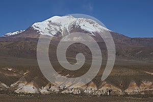 Snow covered Guallatiri volcano on the Altiplano of northern Chile photo