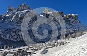 The snow-covered hamlet of Colfosco at the foot of the rock faces of the Stella Massif, Dolomite, South Tyrol, Italy
