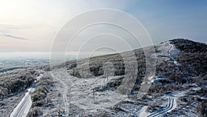 Snow-covered hill in countyside