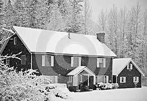 Snow covered home in forest photo