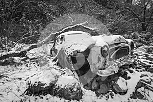 Snow covered junk car.
