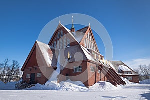 Snow covered Kiruna Church in the shape of a Sami goahti in Kiruna, Sweden