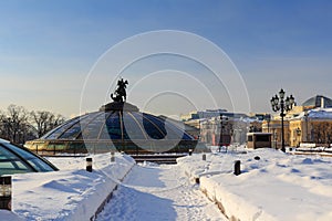 Snow-covered Manege square on the background of World Clock Fountain. Winter in Moscow