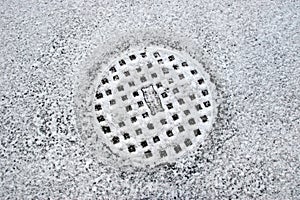 Snow covered manhole cover