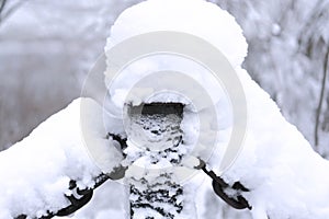 Snow-covered metal chain on the white snowy background