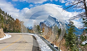 Snow-covered Mount Rundle with snowy forest mountain road. Mount Norquay Scenic Drive. Banff National Park