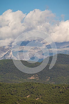 Snow covered mountain with blue sky, cloud and fog