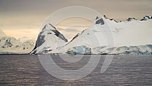 Snow covered mountain landscape in Antarctica around Cuverville Island.