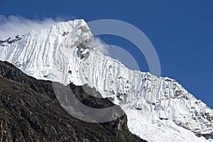 Snow covered mountain peak and blue sky, Cordillera Blanca, Peru