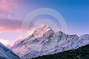 Snow covered mountain peak at sunset. Winter mountains landscape