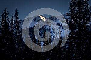 Snow Covered Mountain Peak at Sunset in the Winter Time