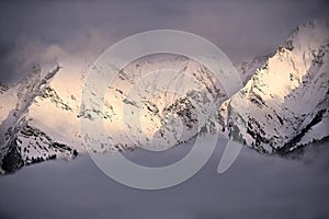 Snow-covered mountain peaks in GraubÃ¼nden, Swiss Alps