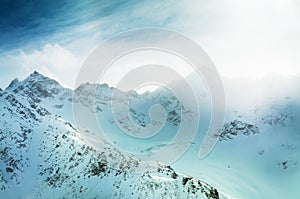 Snow-covered mountain peaks at sunset.