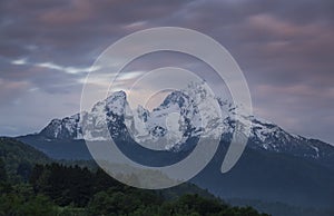 Snow covered mountain peaks of Watzmann at Berchtesgaden with clouds during sunrise, Bavaria