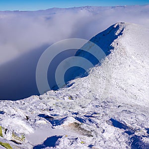 Snow covered mountain ridge running into a peak